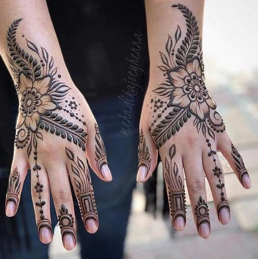 Matching floral henna tattoo on both hands.