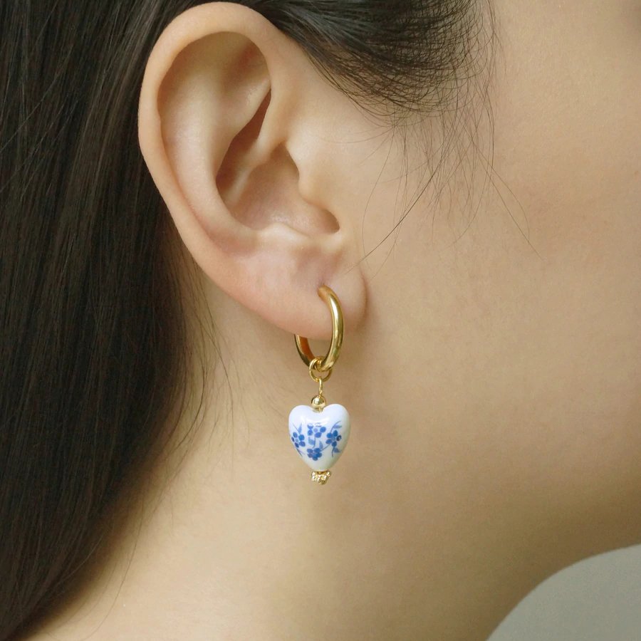 A model wearing Blue & White Heart Earrings.