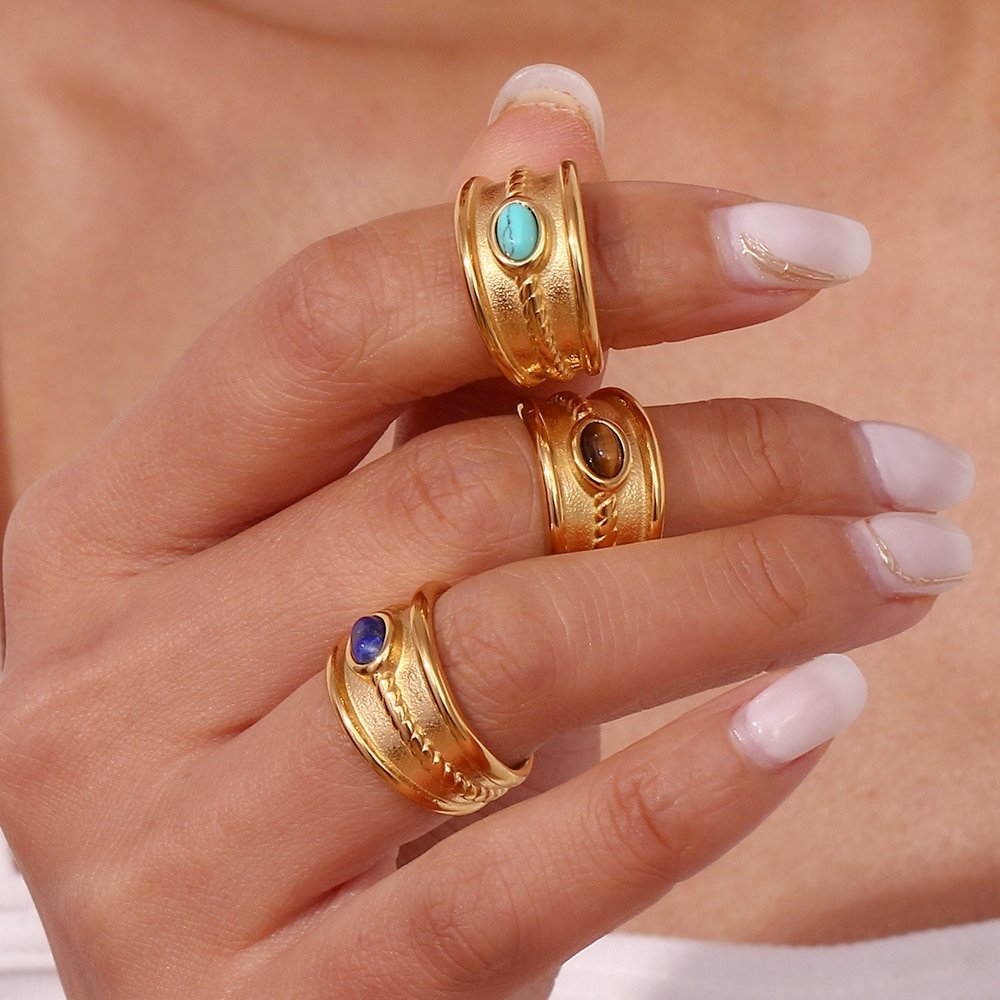 A woman wearing a tigers eye gold ring.