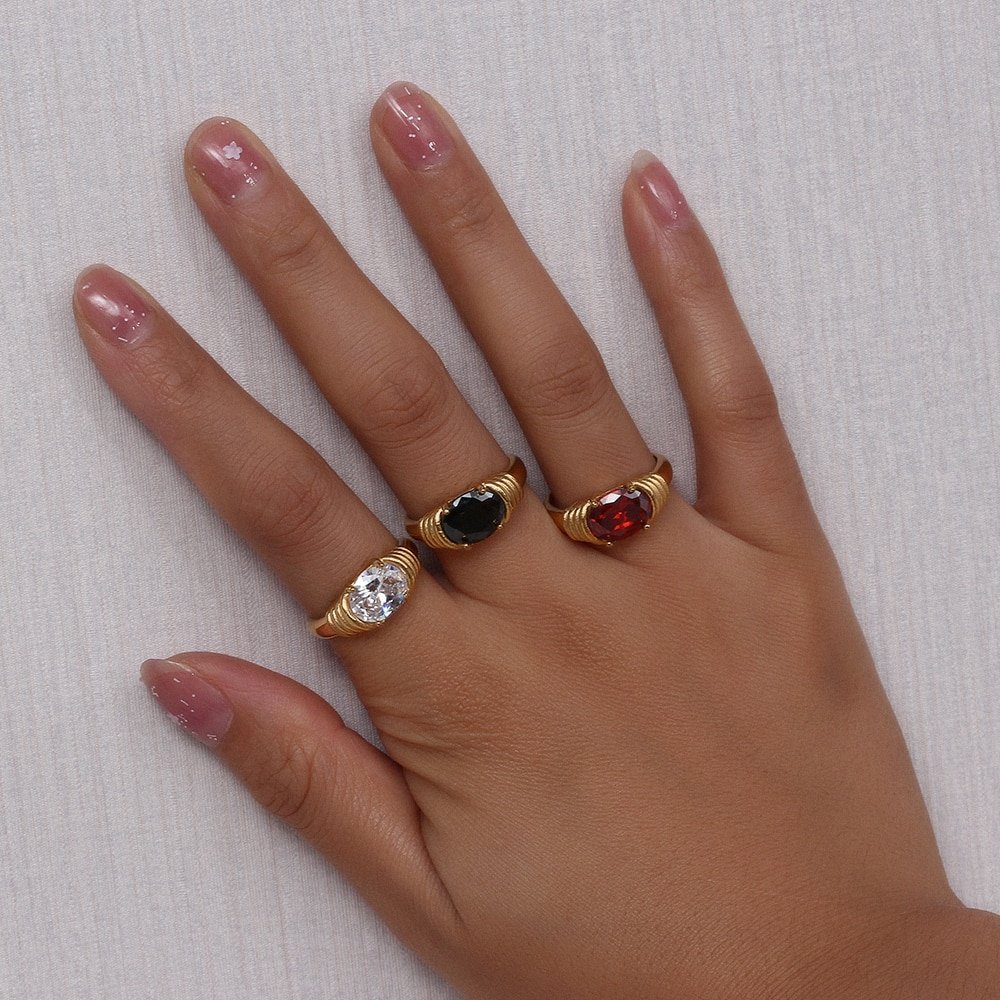 A model wearing three chunky gold rings.