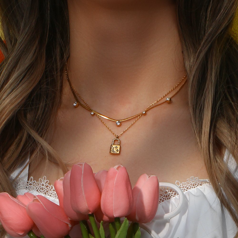 A model wearing a celestial moon padlock necklace.