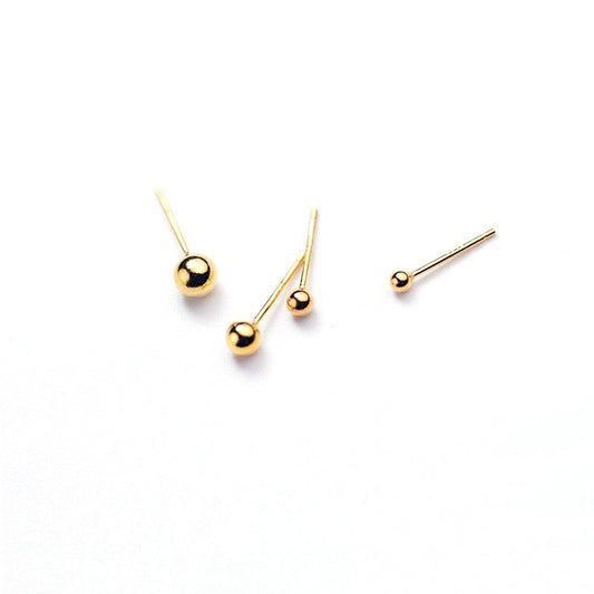Simple gold ball stud earrings.