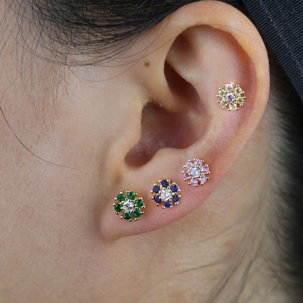 A model wearing multiple Colorful CZ Flower Studs.