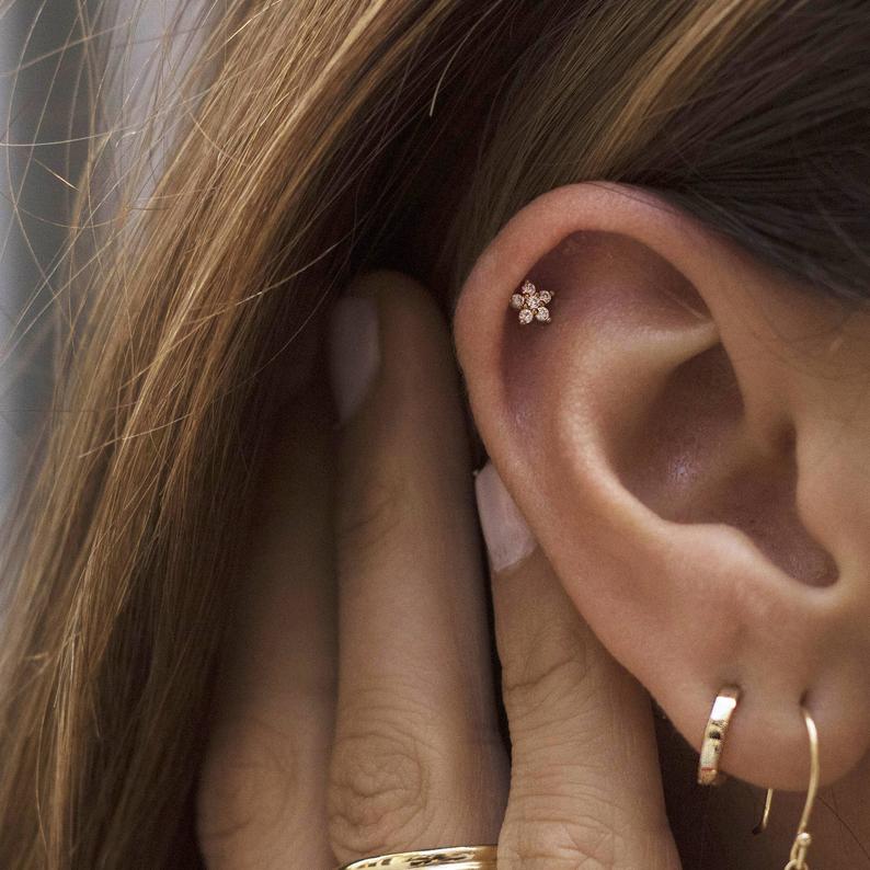 A model wearing the CZ Flower Studs in the cartilage piercing.