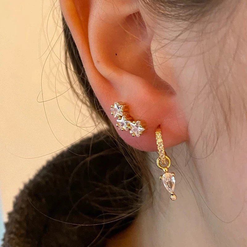 A model wearing star CZ stud earrings.