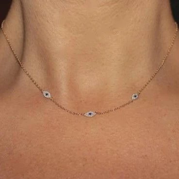A model wearing a gold Delicate Evil Eye Chain Necklace.