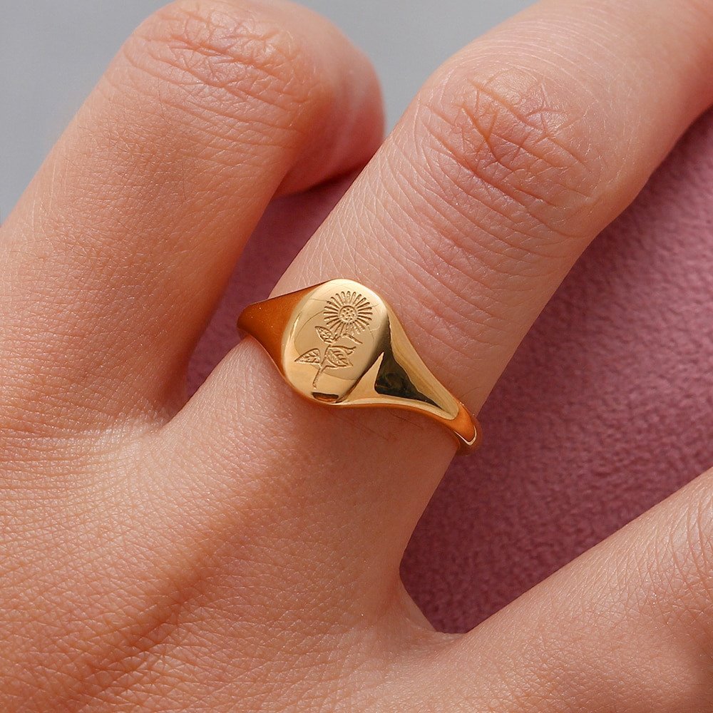 A model wearing the gold Sunflower Signet Ring.