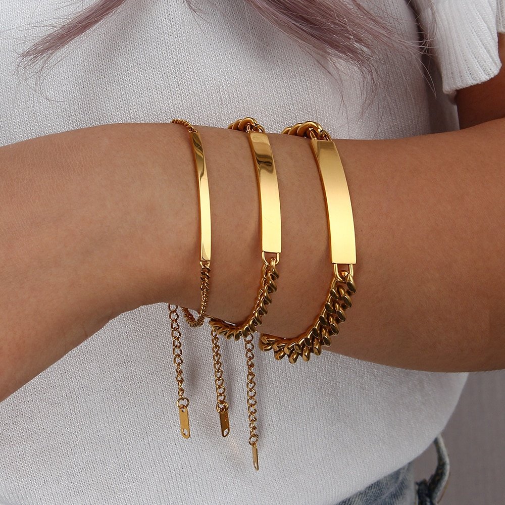 A model wearing three Gold Cuban Link Plate Bracelets.