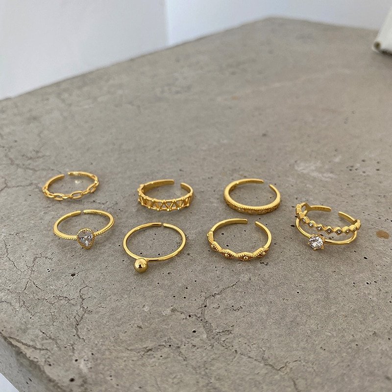 Multiple gold rings on a table.