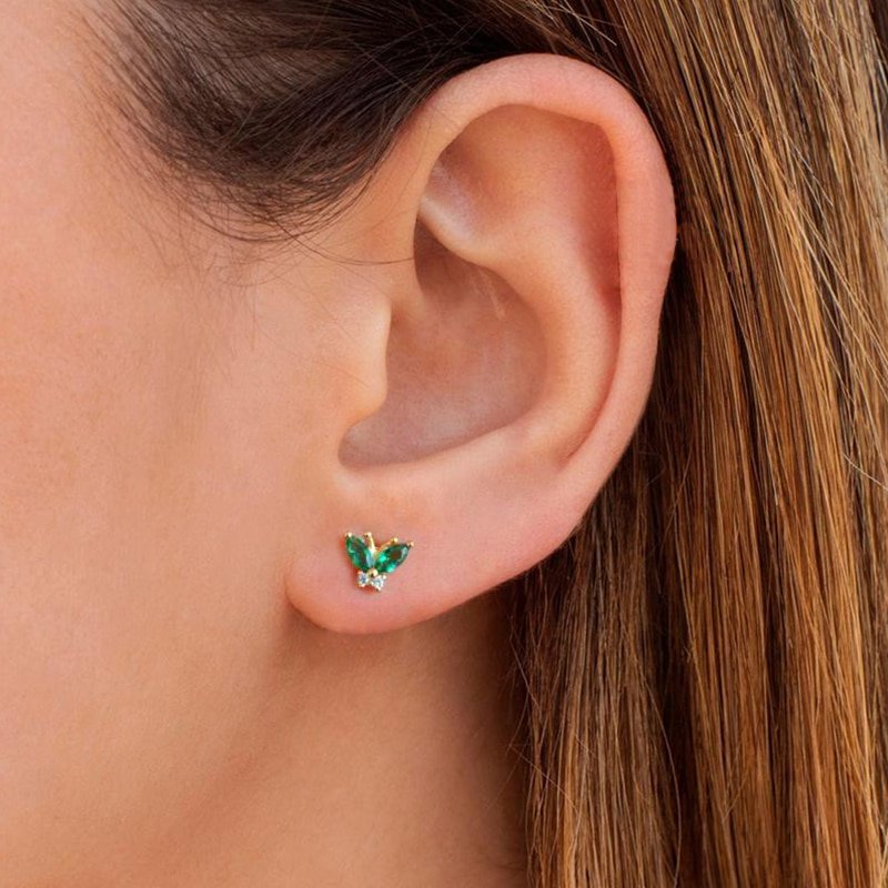 A woman wearing the Green CZ Butterfly Studs.