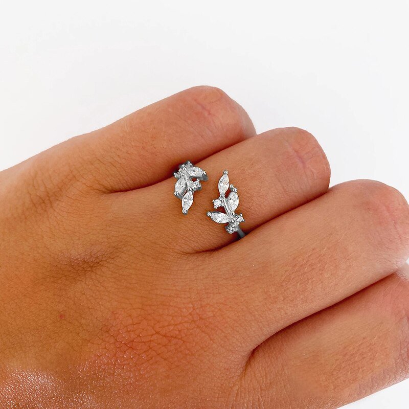 A model wearing a branch wrap ring with CZ stones.