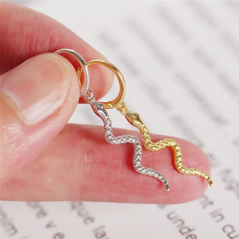 Closeup of the gold and silver Long Snake Dangle Earrings.
