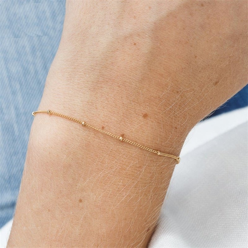 A model wearing the Minimal Satellite Chain Bracelet.