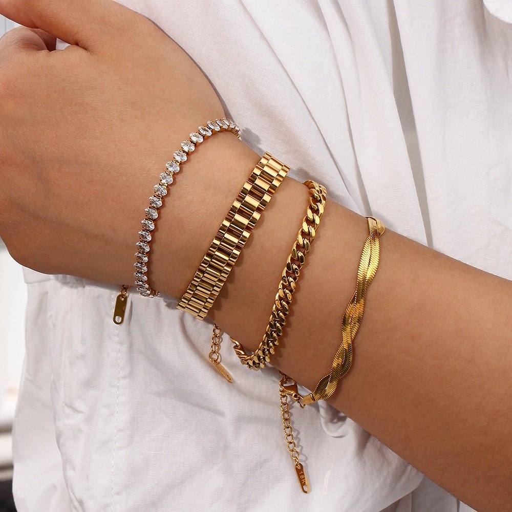 A woman wearing gold bracelets.