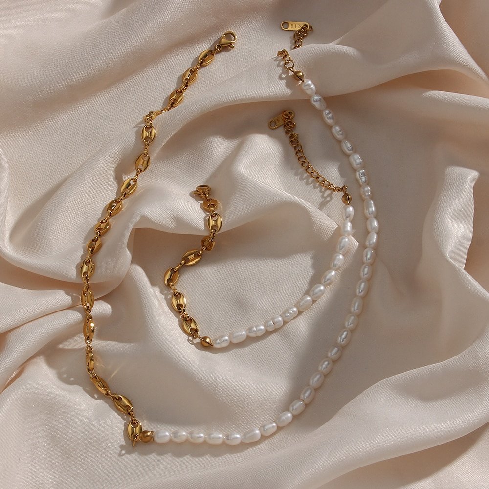 Matching gold and pearl bracelet and necklace set.