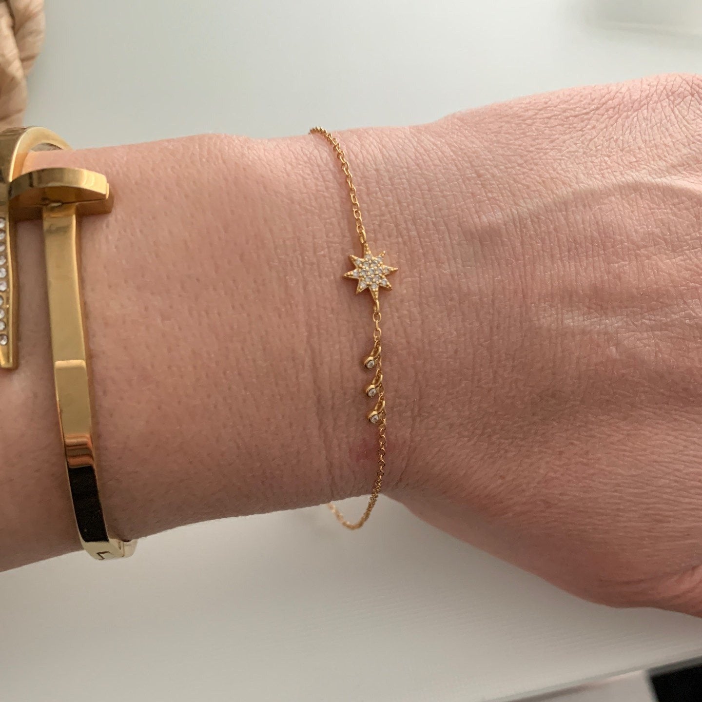 A model wearing the Star CZ Gold Bracelet.