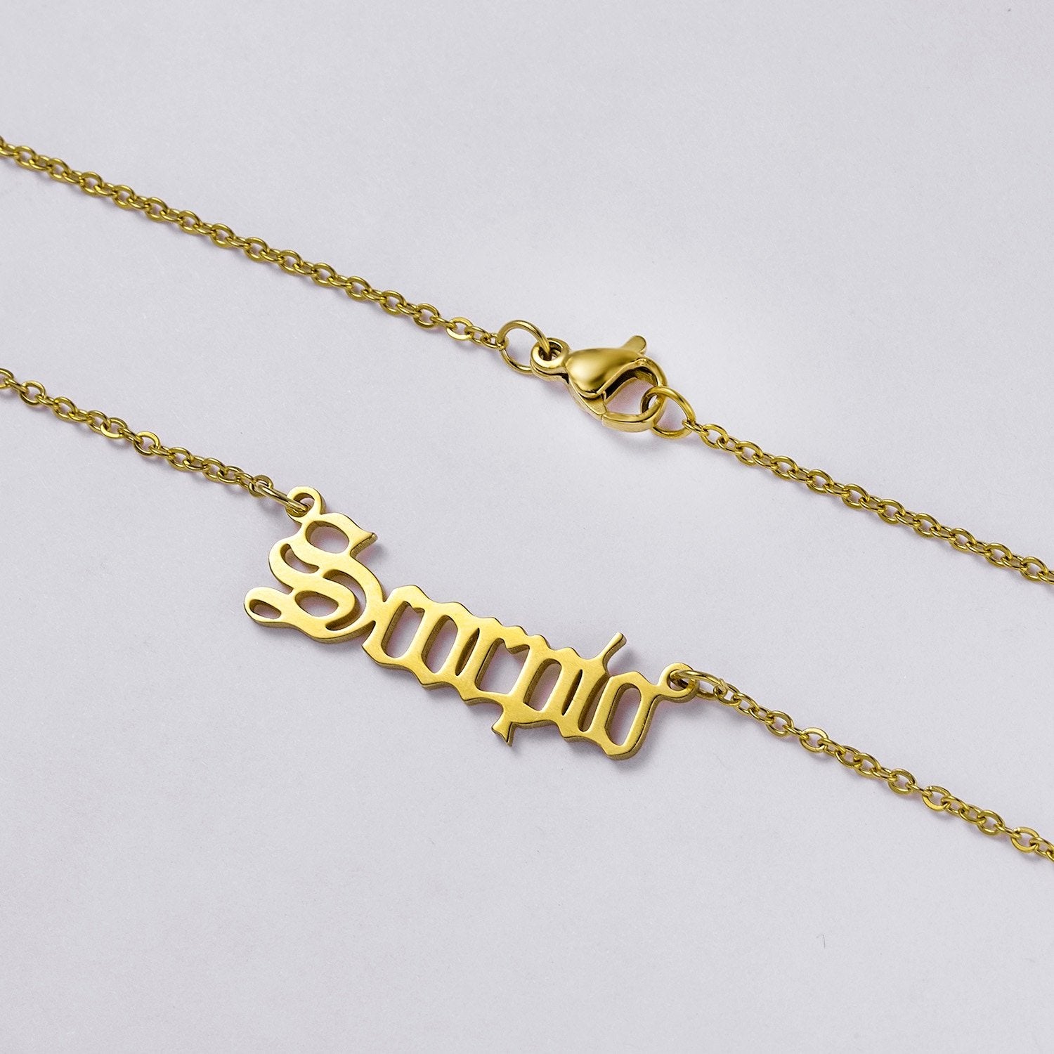 Closeup of the Scorpio Name Plate Necklace.