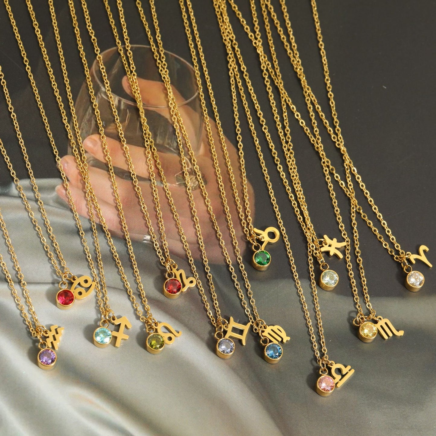 Twelve horoscope birthstone necklaces in gold.
