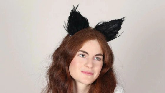 A woman wearing furry cat ears.