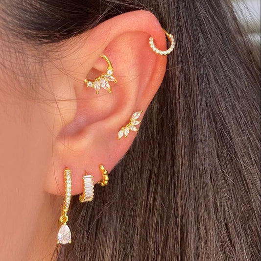A woman with multiple ear piecings with cartilage earrings.