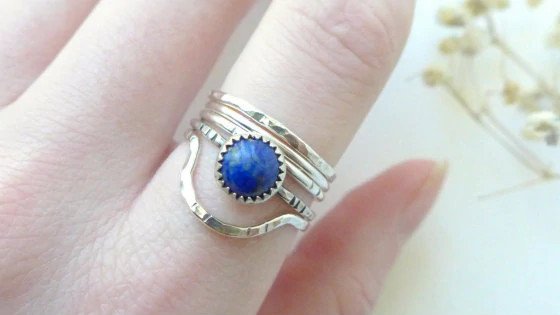 Silver stacking ring with a blue stone.