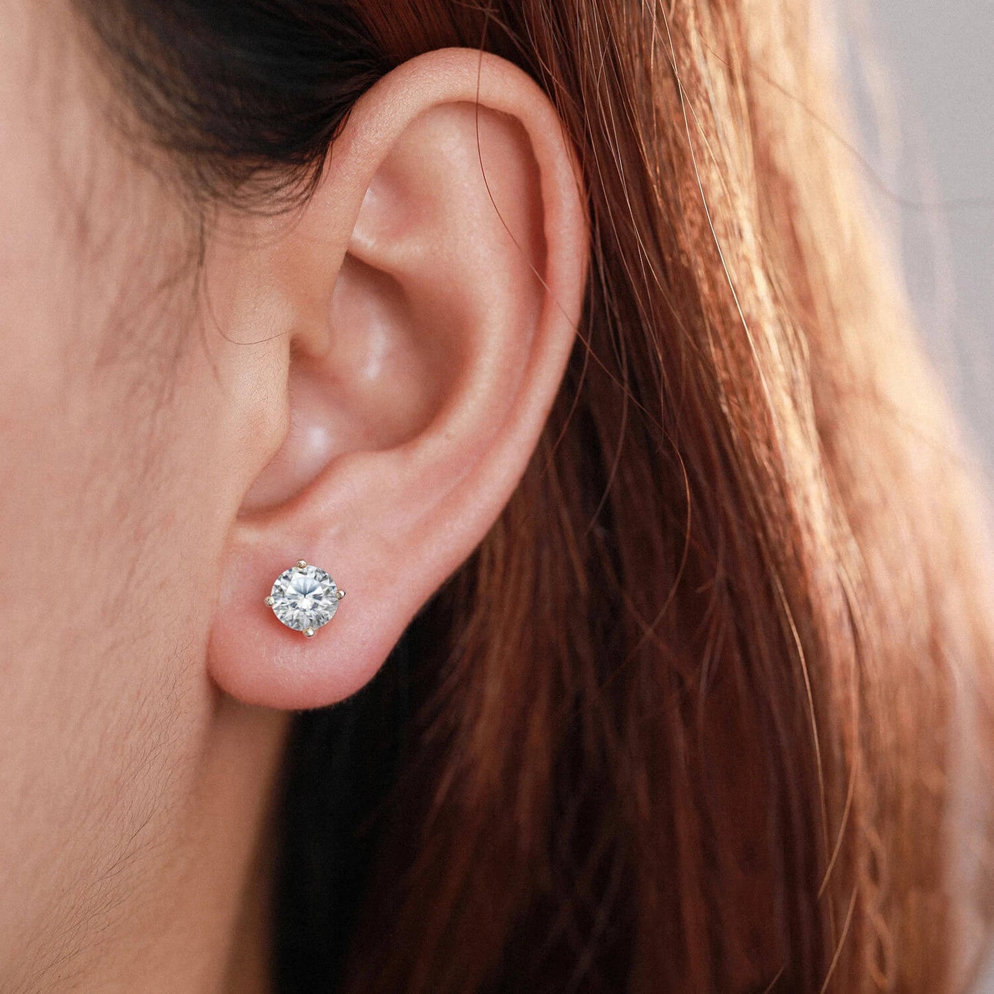 A woman wearing the Audrey Gold Studs.