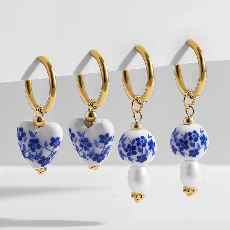 Ceramic beaded earrings on gold hoops.
