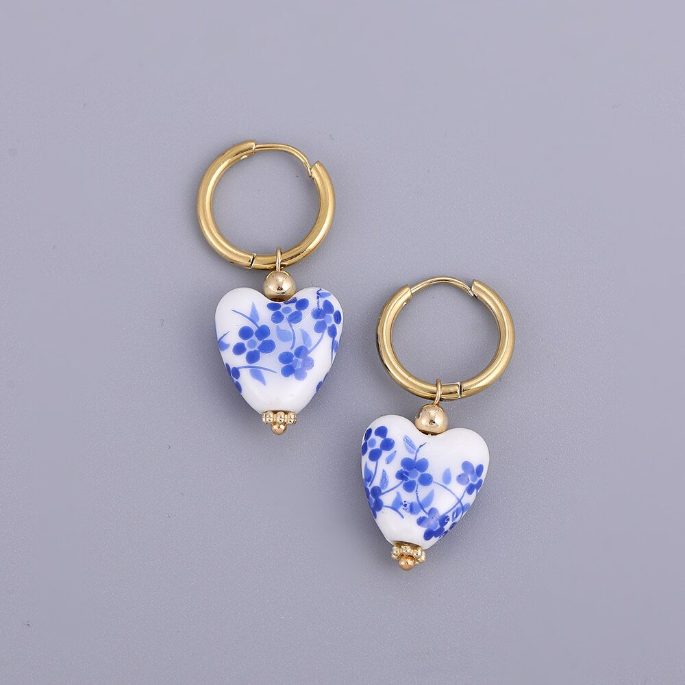 Blue and white ceramic heart earrings.
