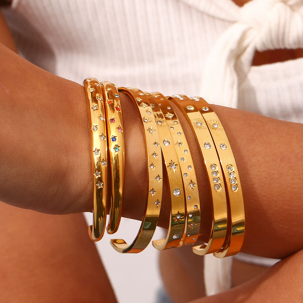 A model wearing the Celestial Gold Stacking Bracelets.