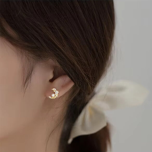 A model wearing the Crystal Pearl Moon Studs.