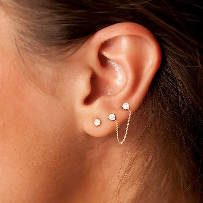A woman wearing the Double Stud Chain Earring Set.