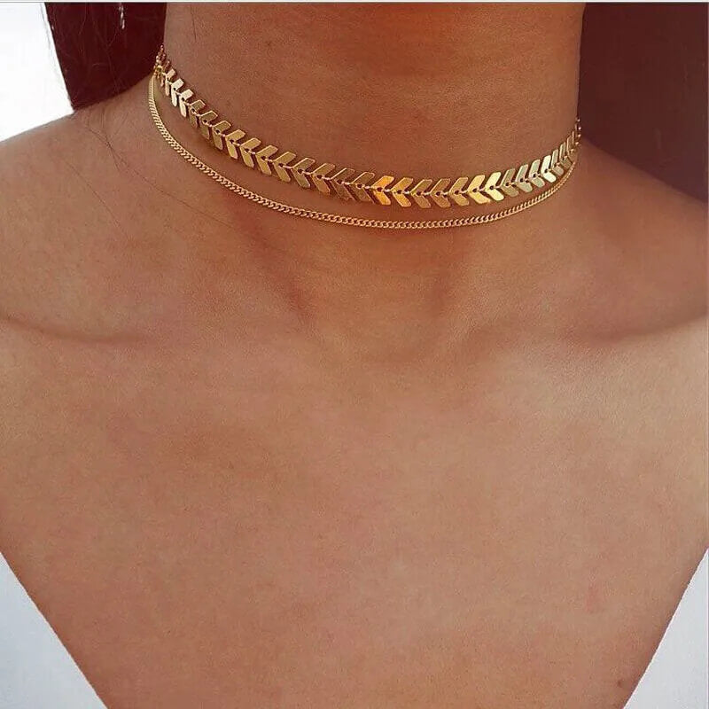 A model wearing the Fishbone Choker Layering Necklace Set.