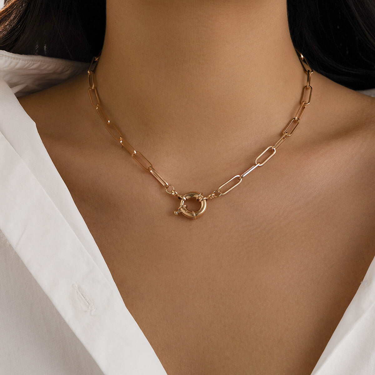 A model wearing the Front Clasp Gold Paperclip Necklace.