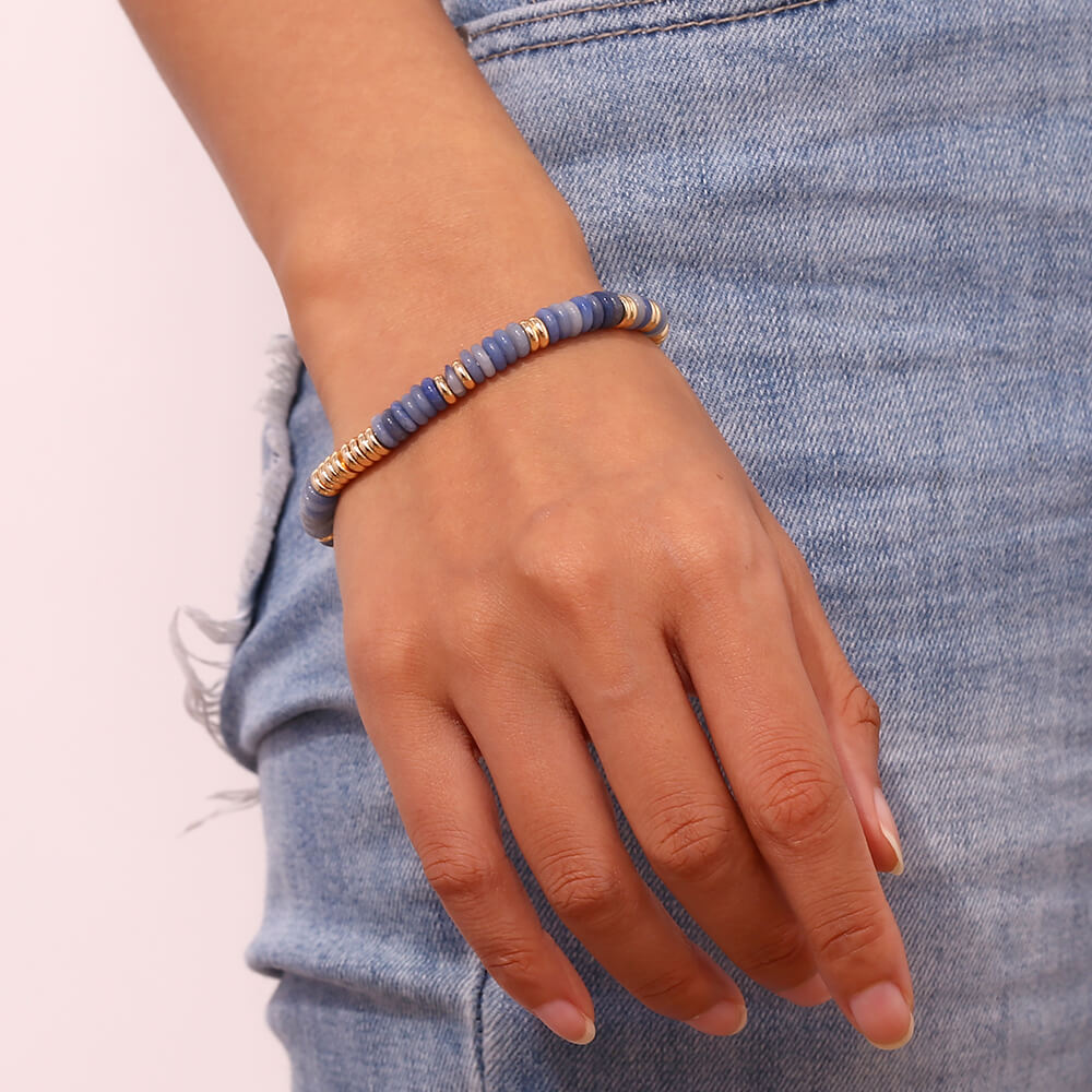 A woman wearing the Gemstone Rondelle Beaded Gold Bracelet.