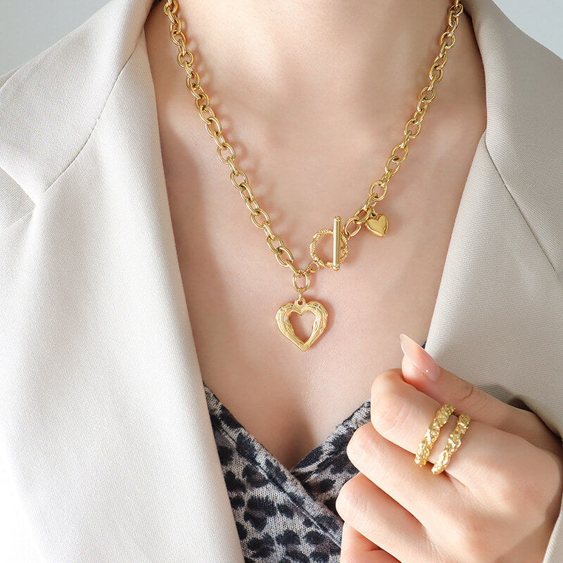 A woman wearing the Heart Font Clasp Gold Necklace.