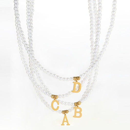 Multiple Pearl Initial Gold Necklaces.