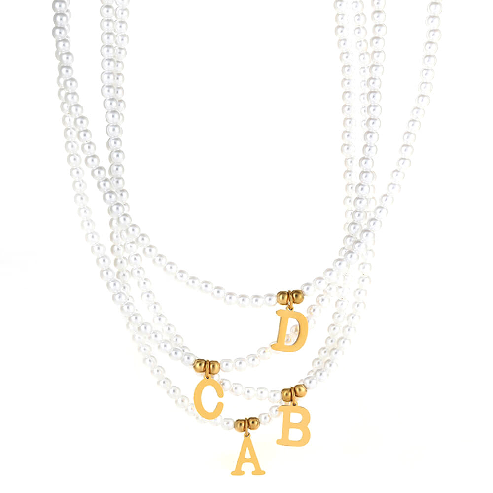 Multiple Pearl Initial Gold Necklaces.