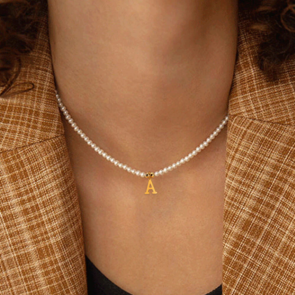 A model wearing the Pearl Initial Gold Necklace.