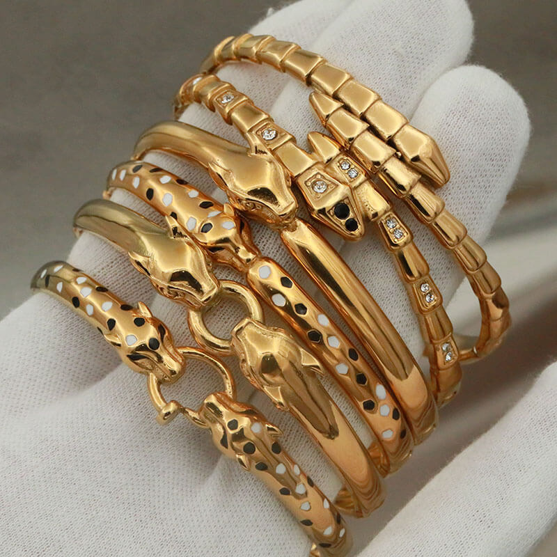 Multiple gold snake bangles.