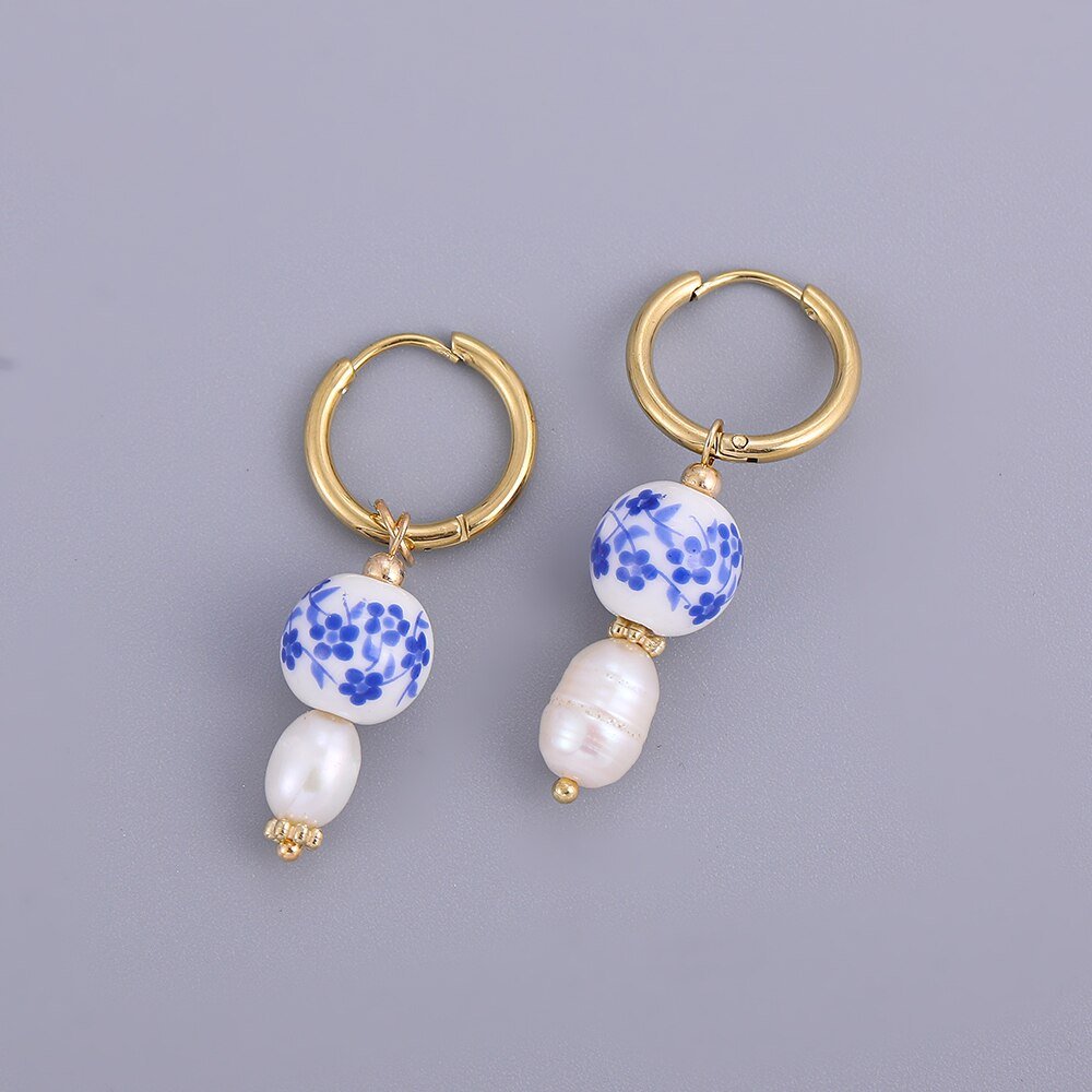 Gold hoops with blue and white ceramic beads.
