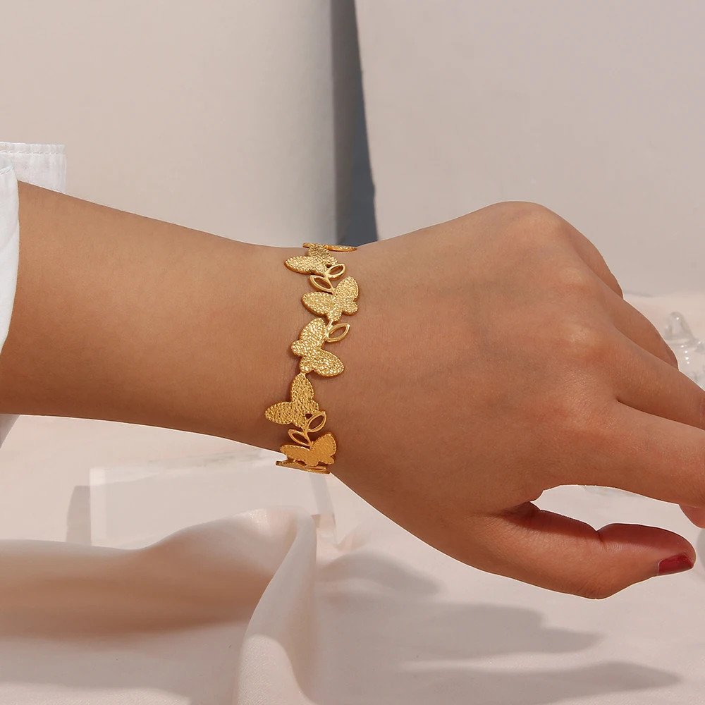 A woman wearing the Butterfly Gold Cuff Bracelet.
