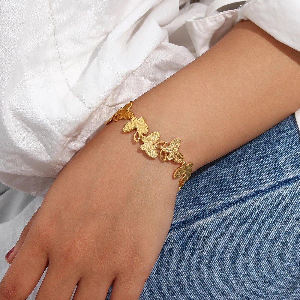 A model wearing the Butterfly Gold Cuff Bracelet.