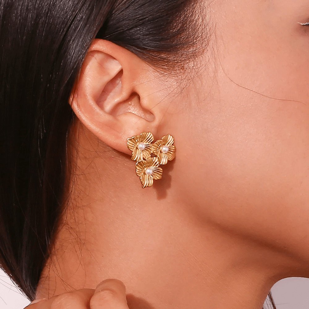A model wearing the Flower Cluster Gold Pearl Earrings.