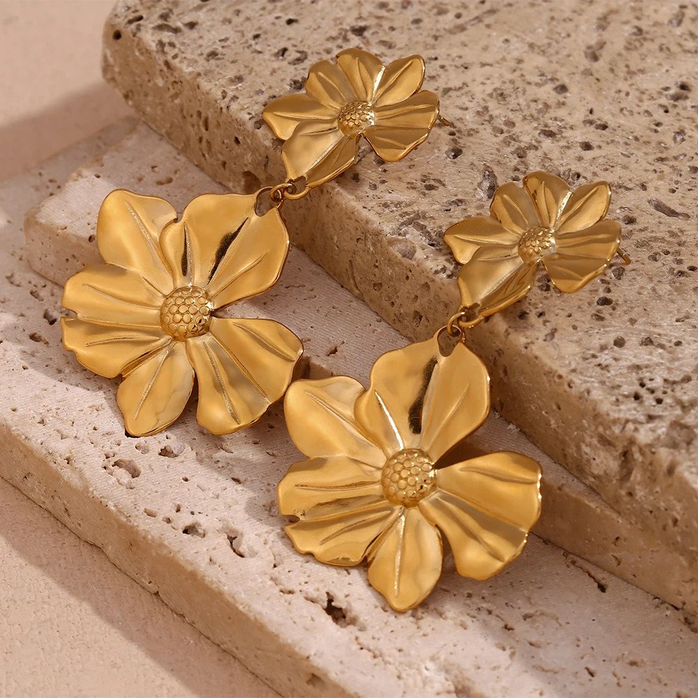 Gold floral dangle statement earrings.