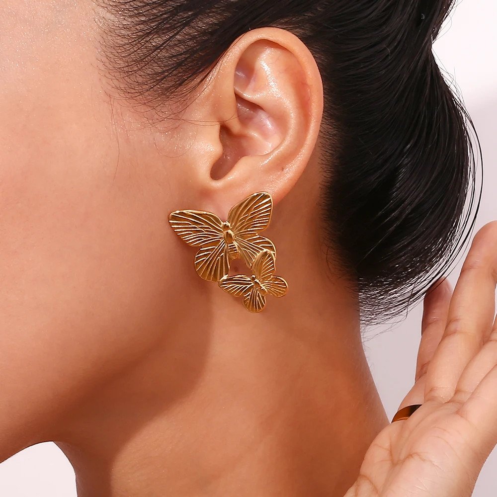 A woman wearing the Large Gold Butterfly Earrings.