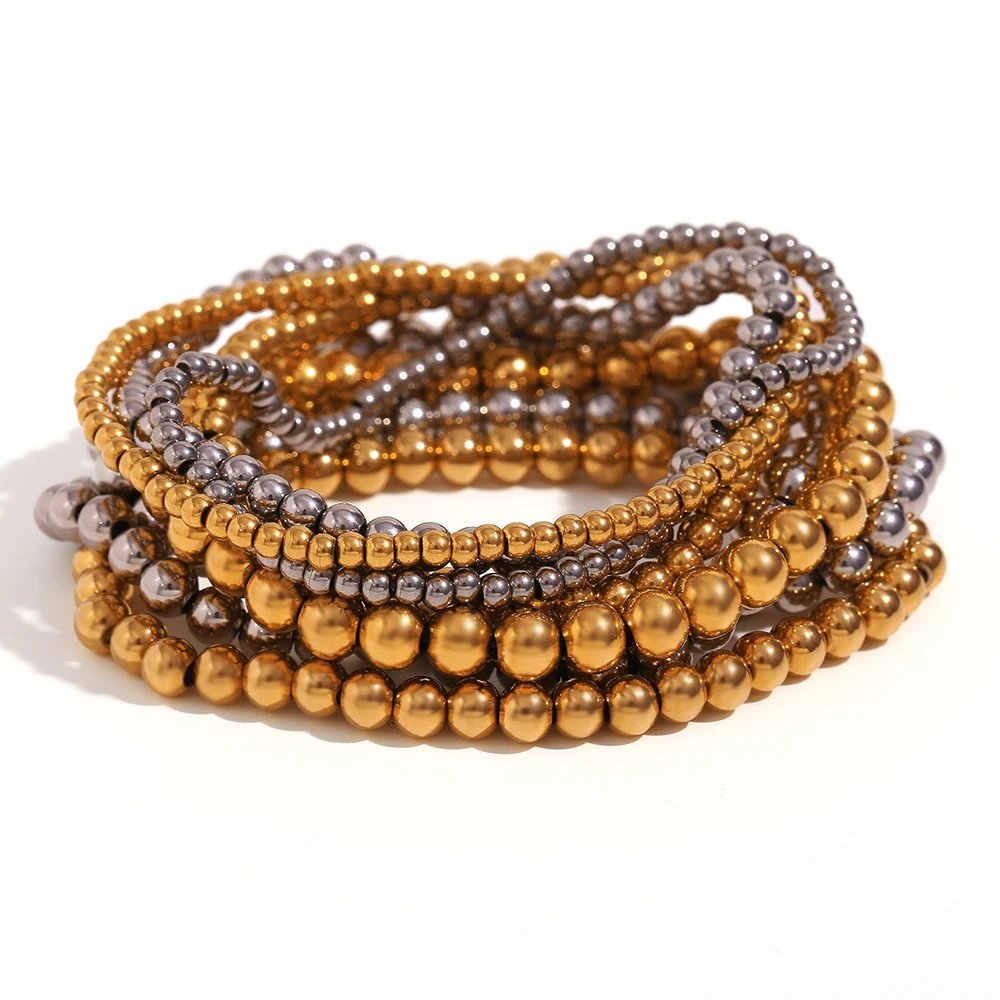 Mixed metal beaded stacking bracelets.