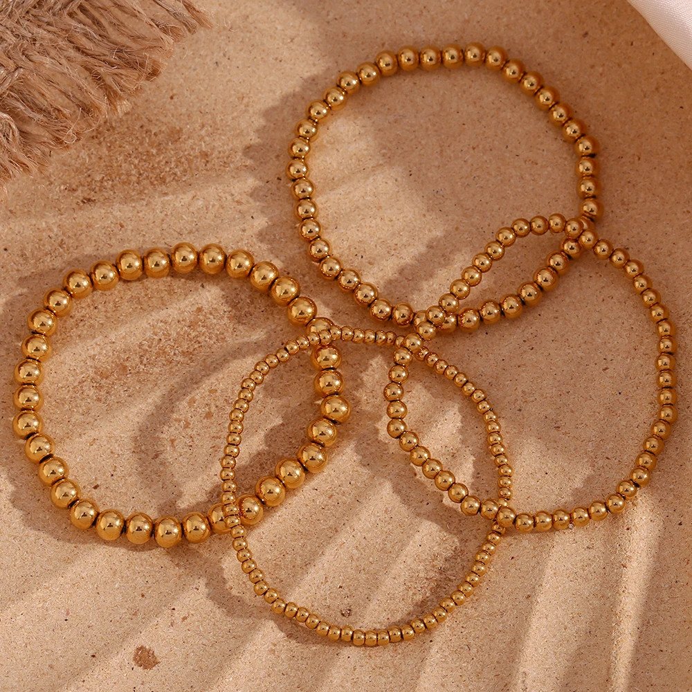 Gold beaded bracelets.
