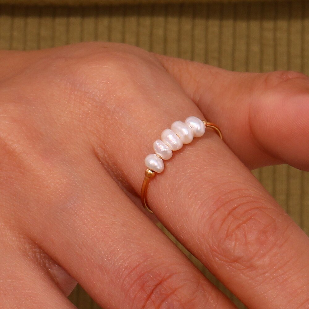 A woman wearing the Organic Pearl Gold Ring.