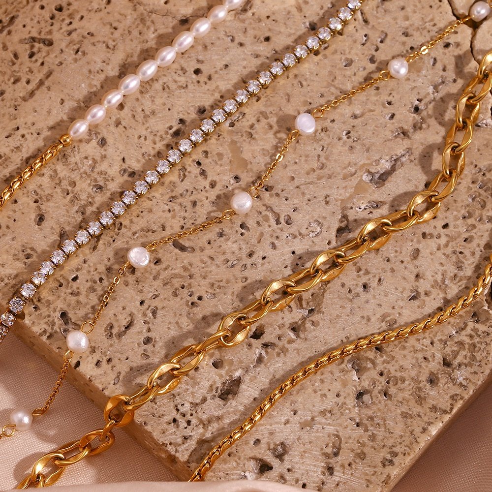 Multiple pearl gold anklets.