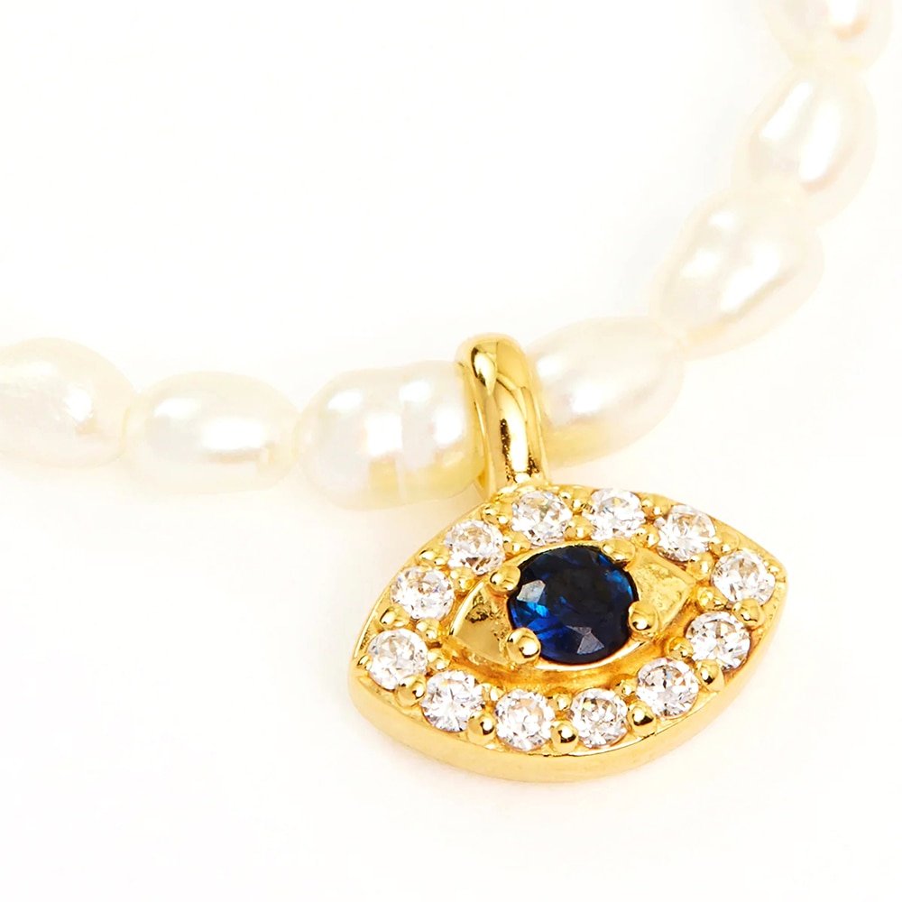 Closeup of the Evil Eye Pearl Charm Gold Necklace.